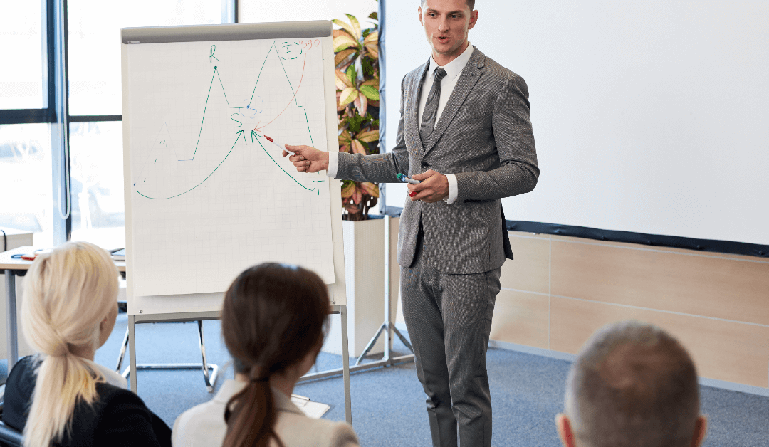A man in a suit is giving a presentation